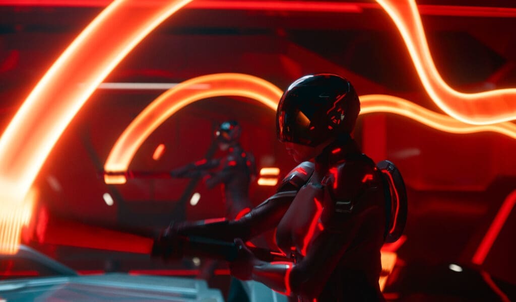 Two helmeted, humanoid figures in glowing red neon suits stand inside a red, futuristic room