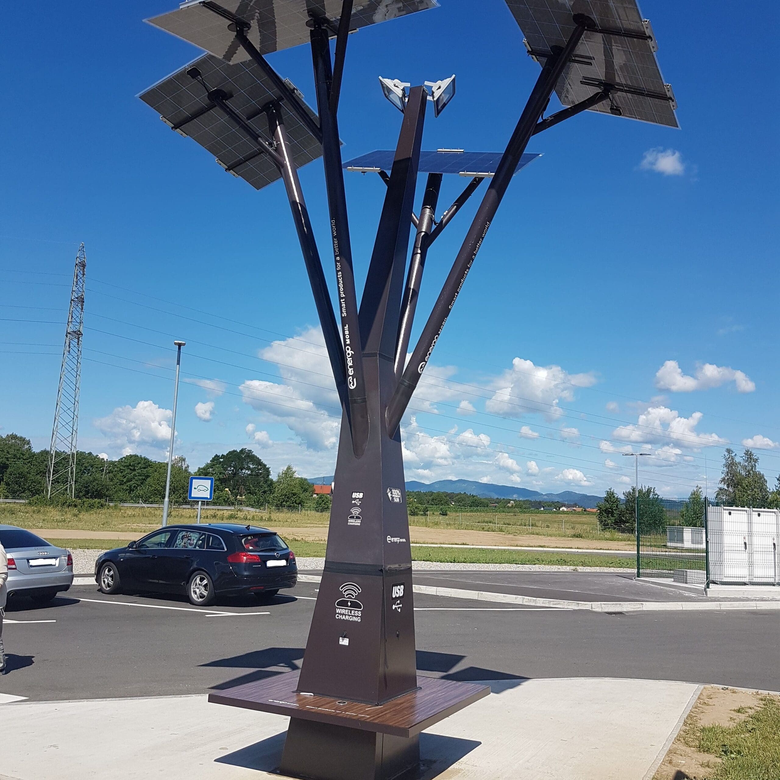 Wireless charging station made from a metal tree construction with solar panels branching out