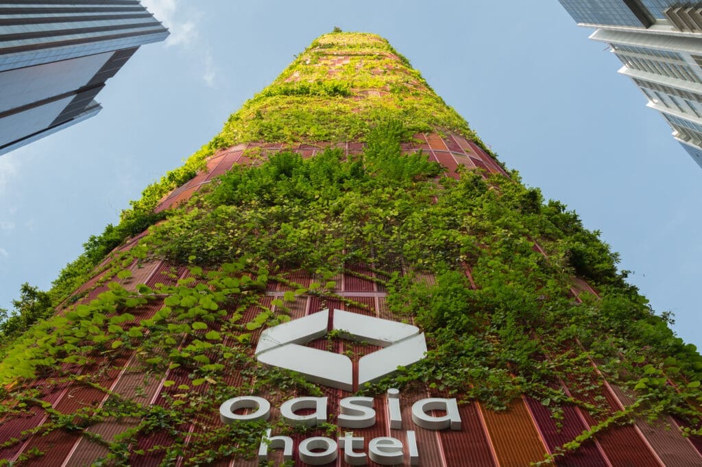 Overgrown green facade of the Oasia Hotel Tower in Downtown  Singapore