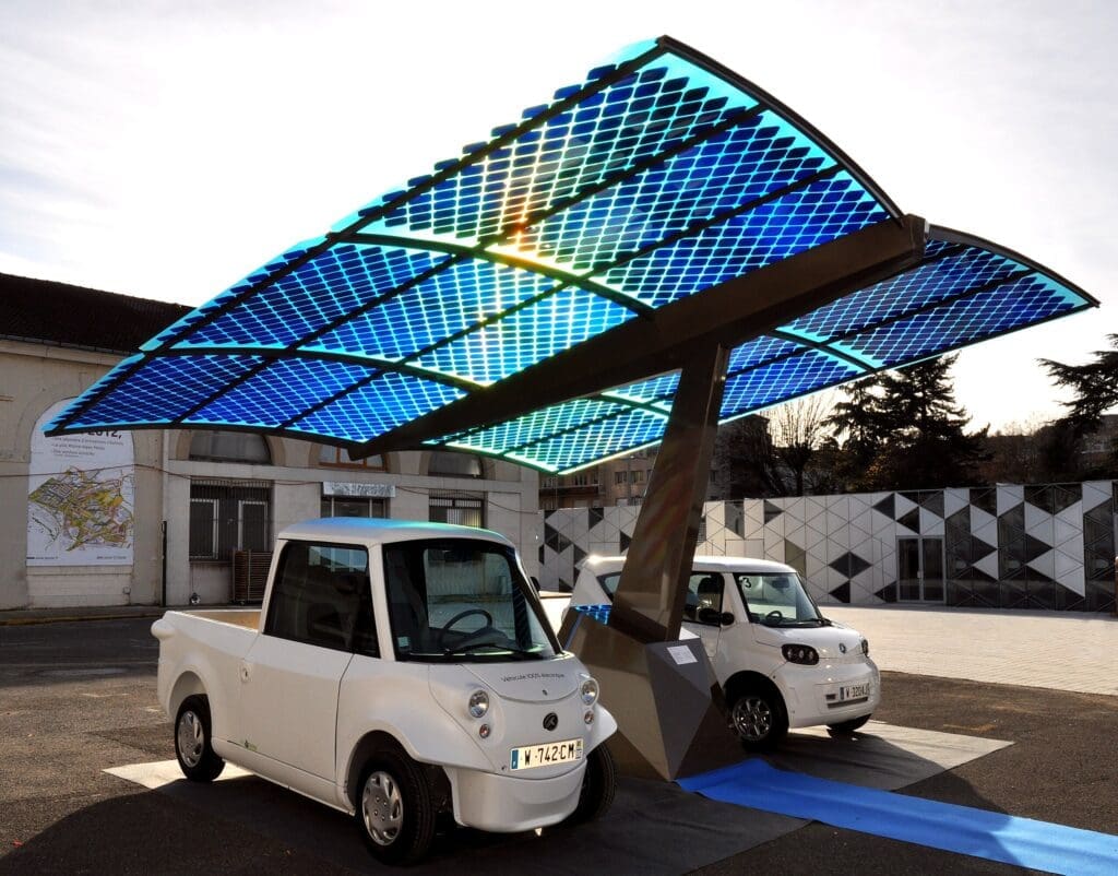 Two EVs charging underneath a blue Solar system roof