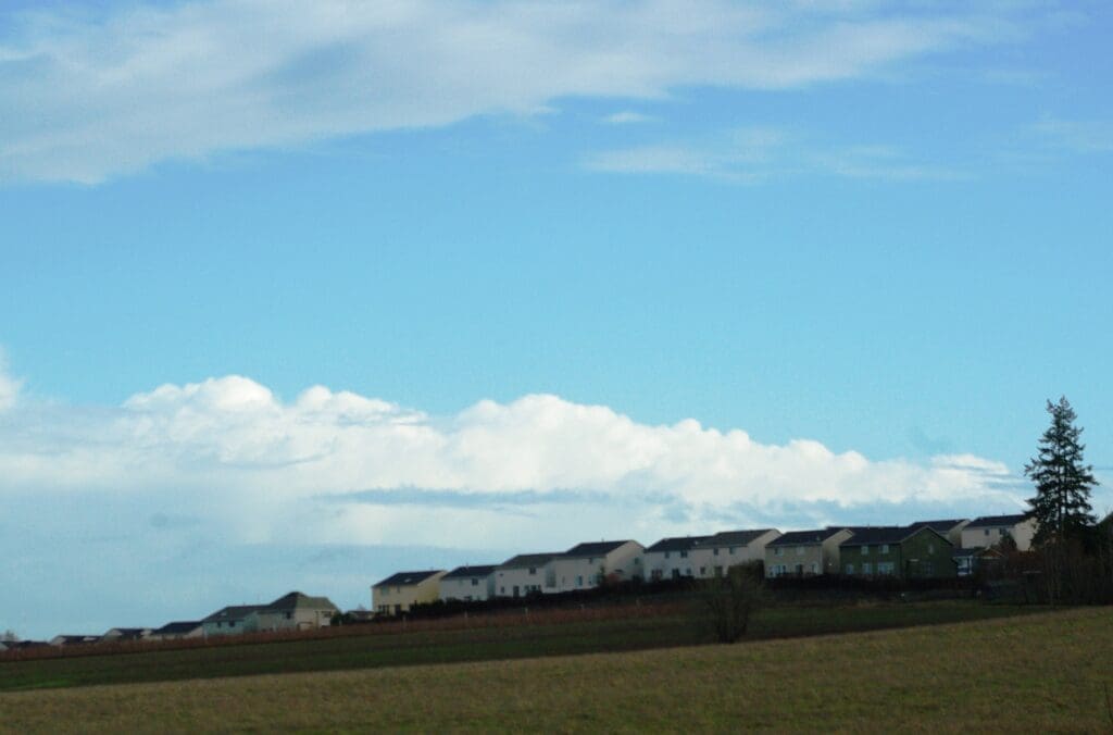 Housing development at the urban edge, with a clear transition to open countryside, illustrating an Urban Growth Boundary (UGB)